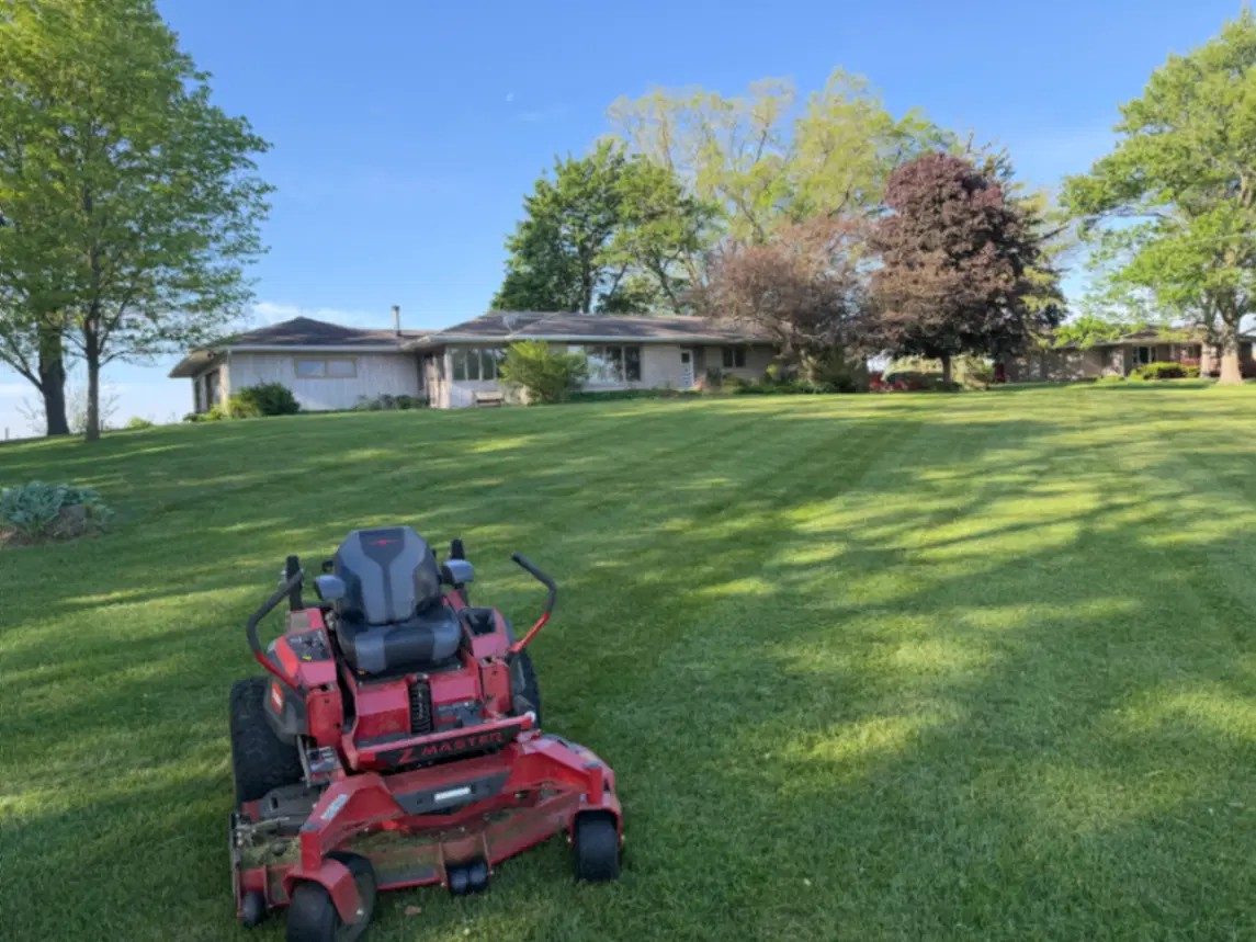 Mowing and string trimming along a riverfront property in Clinton, IA